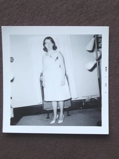 YOUNG LADY WITH CATS EYE GLASSES AND DRESS WITH LARGE FLOWER 1966 PHOTO